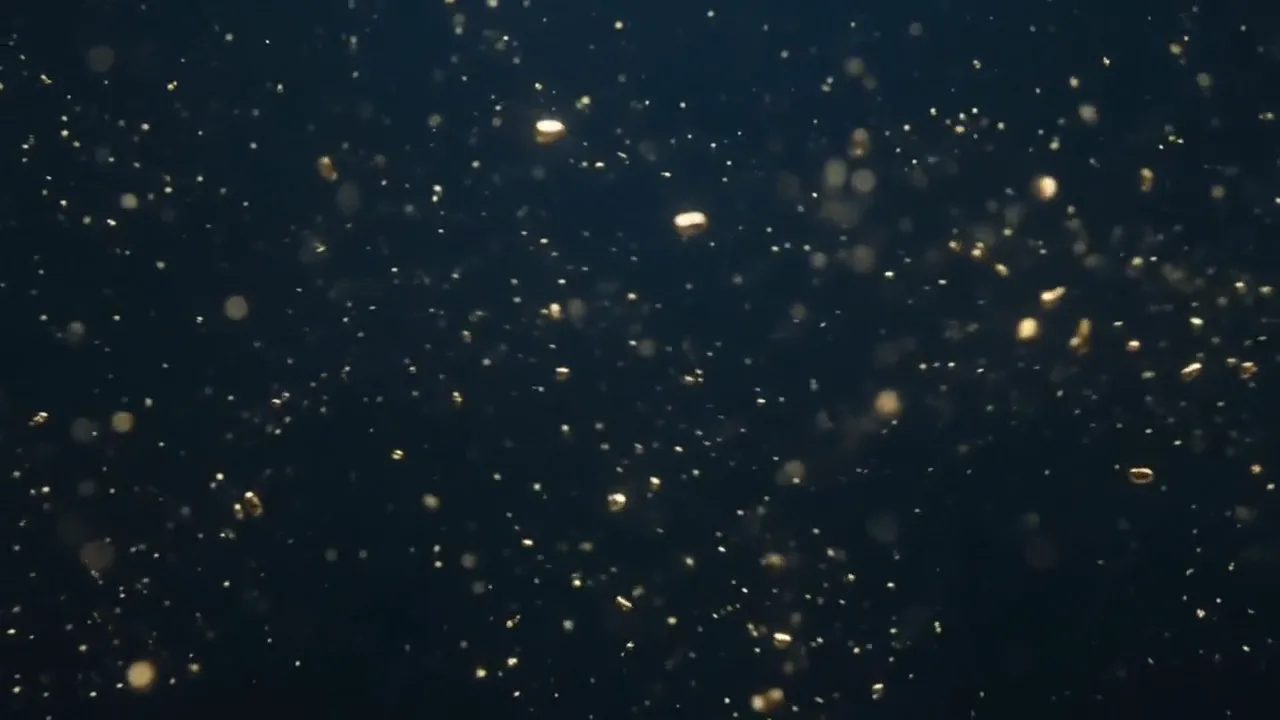 A slow pulse of light moving through dark water